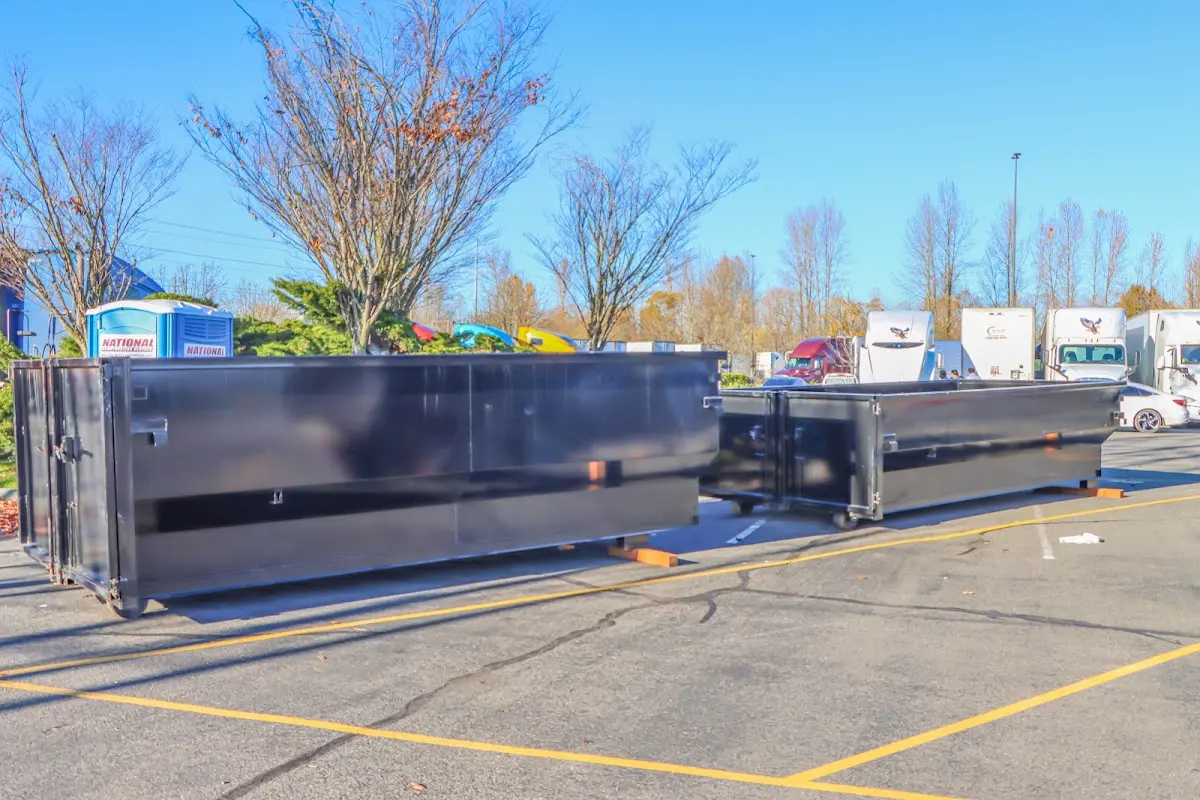 Professional dumpster rental service with roll-off container on residential driveway in Hartsville-Trousdale County